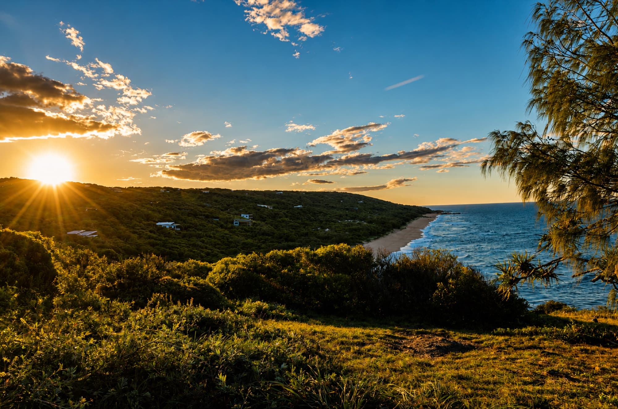 The Long Hold: standing on the ridgeline at sunset, the beach below